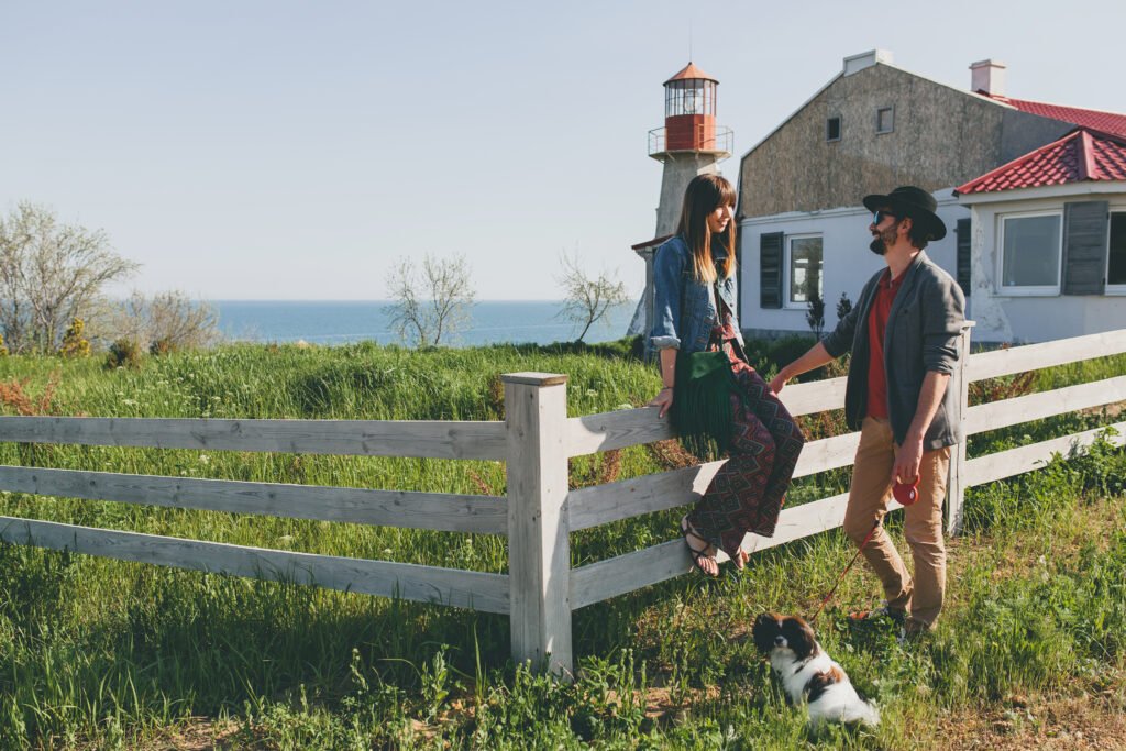 happy young stylish hipster couple love walking with dog countryside